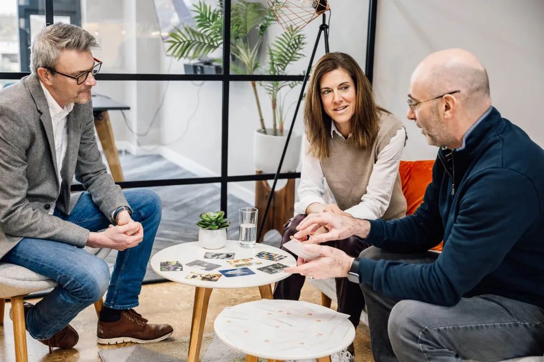 Lisa in conversation with two members of a leadership team