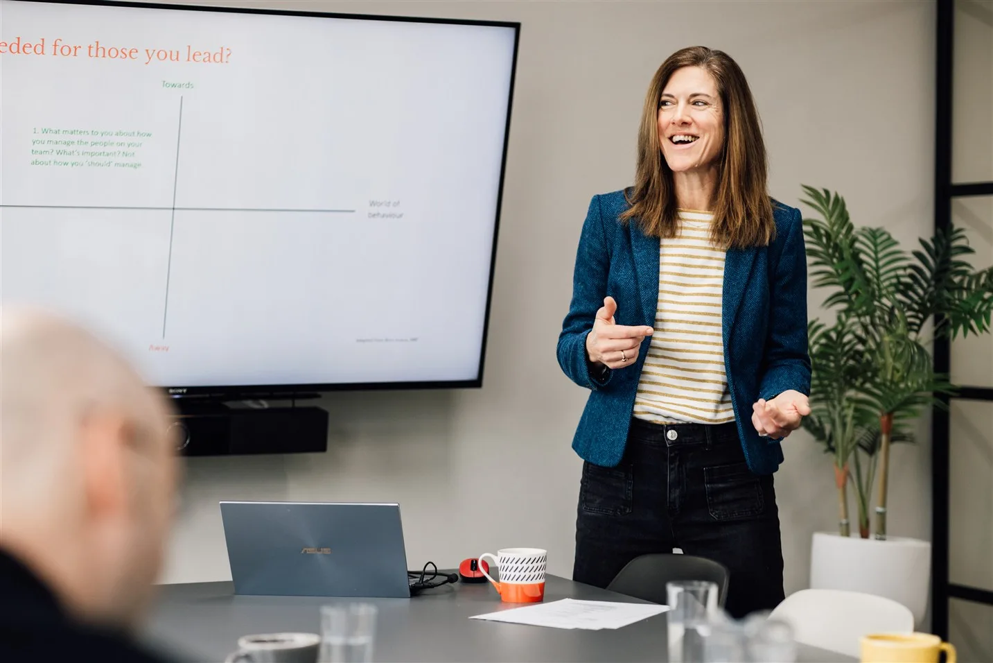 Lisa leading a group session around a meeting table
