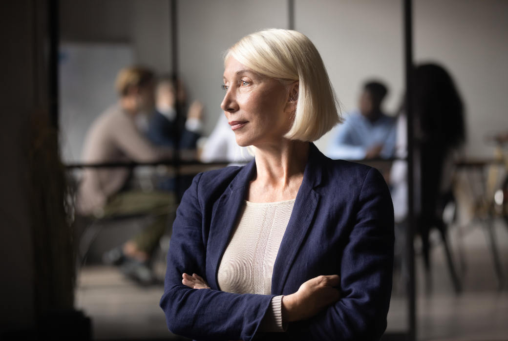 A leader intentionally pausing from the activity of a workplace.